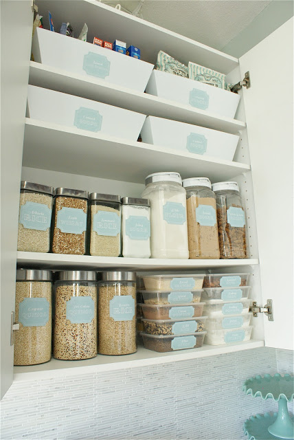 Labelled containers inside a kitchen cabinet